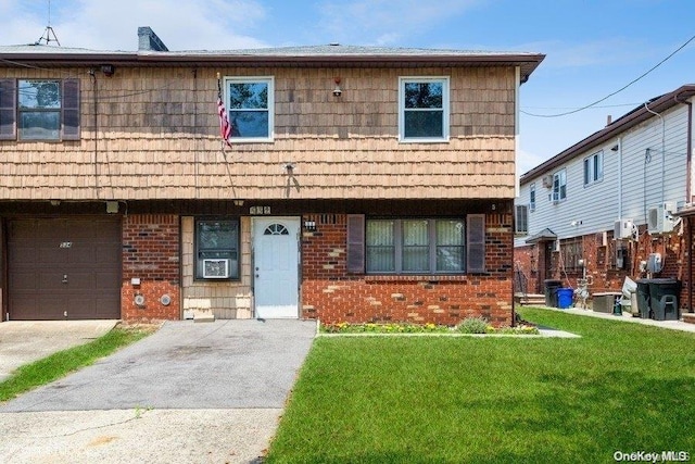 view of front of home featuring a front yard, a garage, and cooling unit