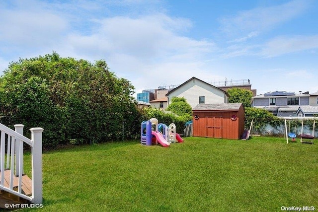 view of yard featuring a playground and a storage shed