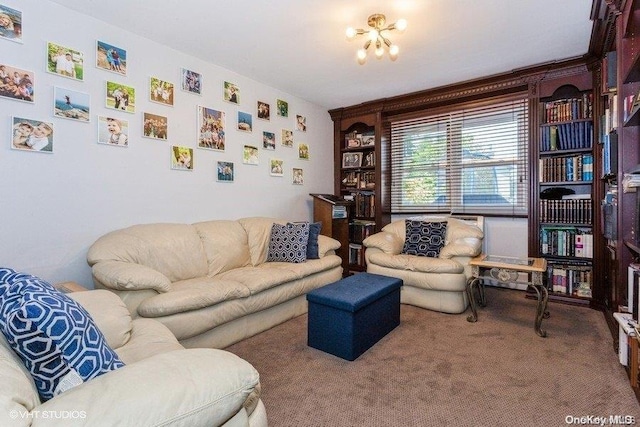 carpeted living room featuring a notable chandelier