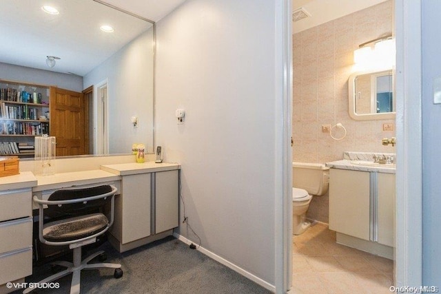 bathroom with tile patterned flooring, vanity, and toilet