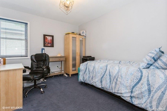 bedroom featuring dark colored carpet