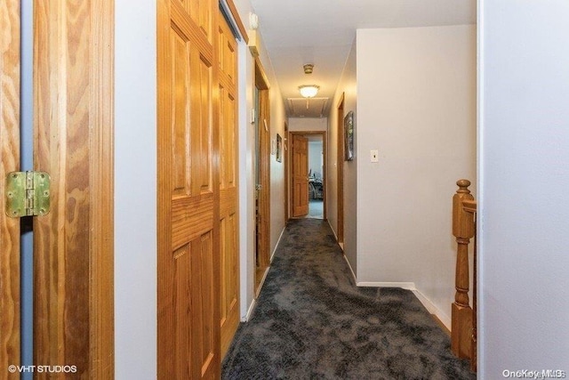 corridor with dark colored carpet