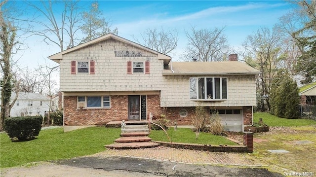 tri-level home featuring a front yard and a garage