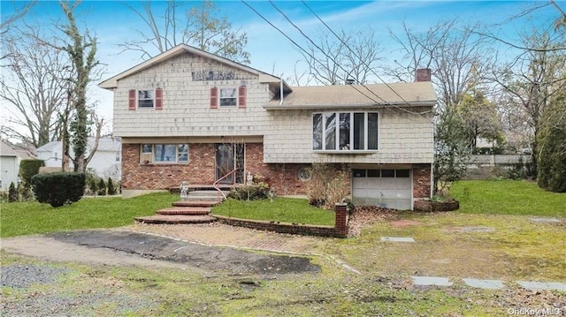 split level home featuring a front lawn and a garage