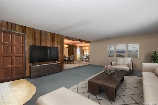 living room featuring light colored carpet, wooden walls, and an inviting chandelier