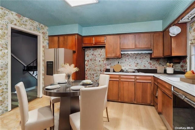 kitchen featuring light hardwood / wood-style floors and black dishwasher