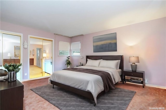 carpeted bedroom featuring two closets