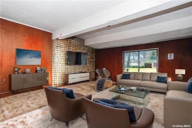 living room with beam ceiling and wooden walls