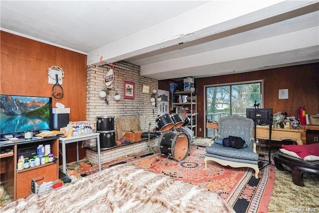 living room featuring beam ceiling and wood walls