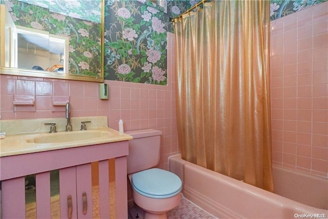 full bathroom with shower / bathtub combination with curtain, toilet, tile walls, and sink