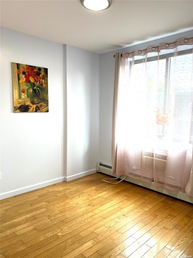 empty room with light hardwood / wood-style flooring