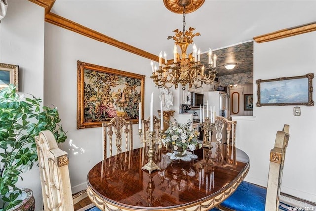 dining space featuring hardwood / wood-style floors, crown molding, and a chandelier