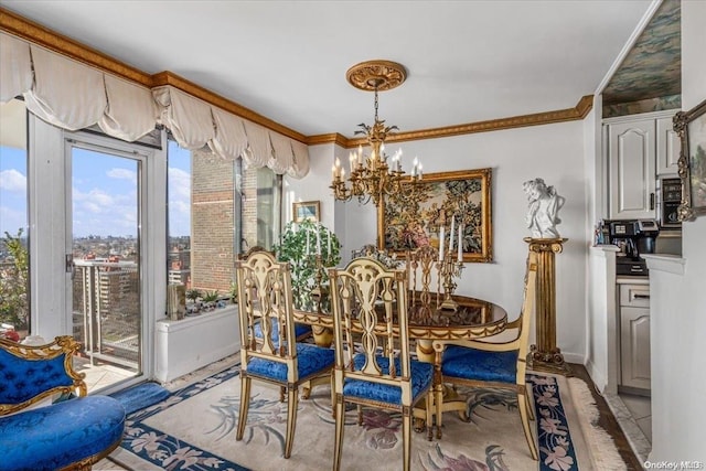 dining room with crown molding and a chandelier