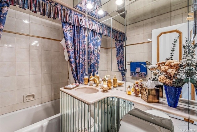 bathroom with vanity, shower / tub combo with curtain, and tile walls