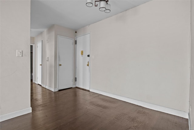 empty room featuring dark wood-type flooring