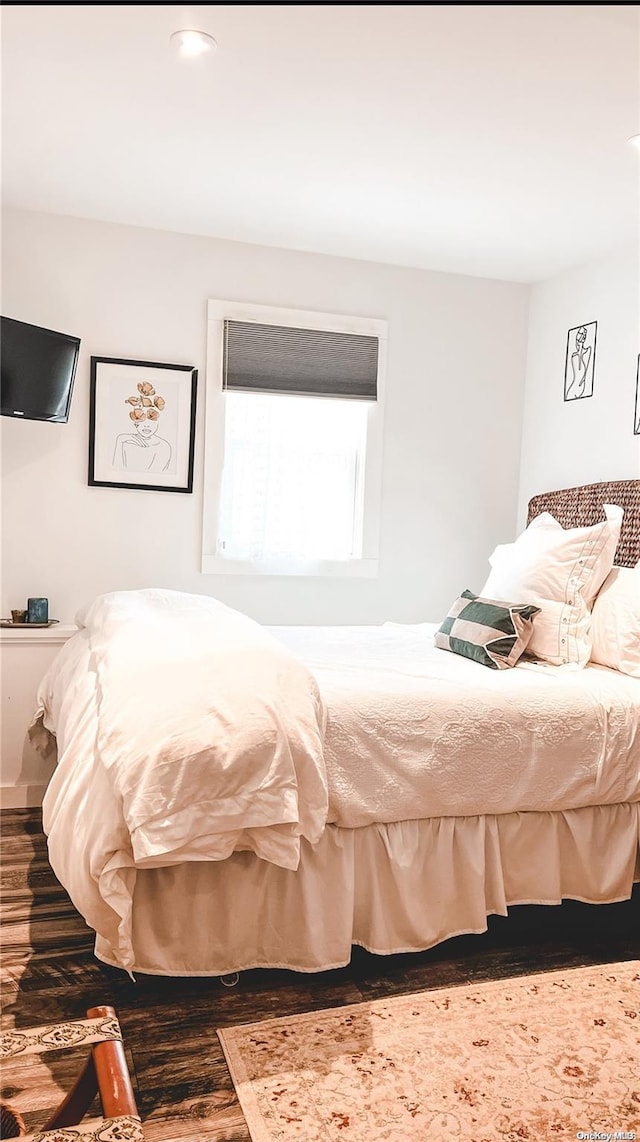 bedroom with dark hardwood / wood-style floors