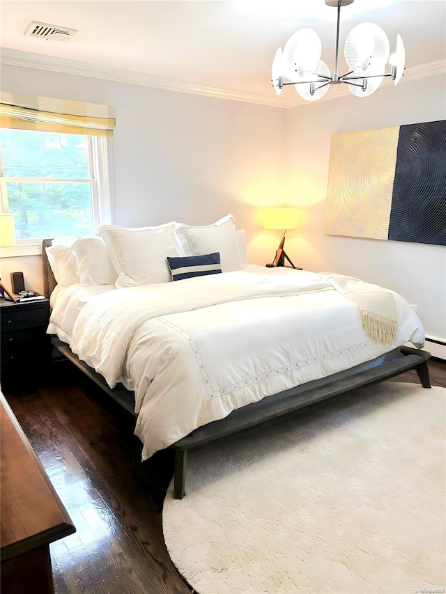 bedroom featuring dark hardwood / wood-style flooring, an inviting chandelier, and crown molding