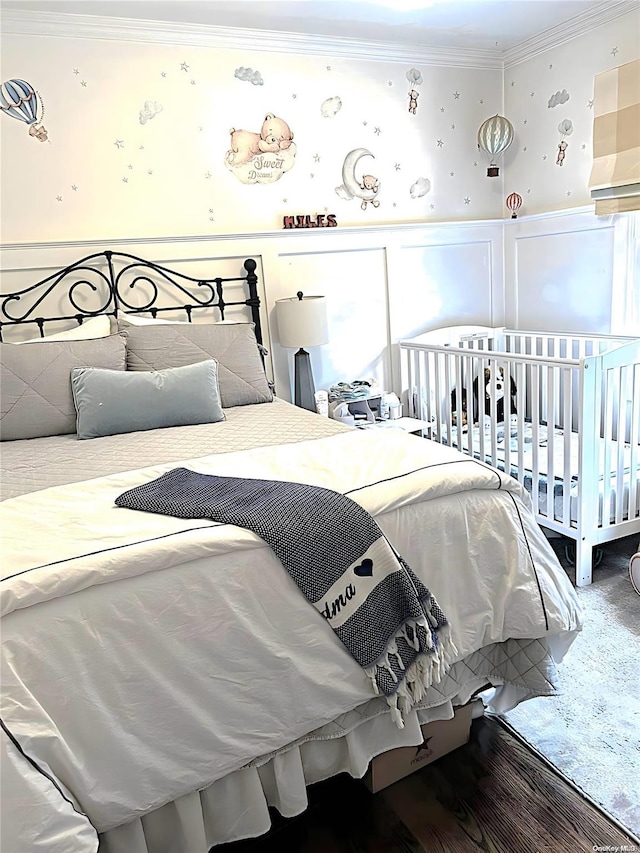 bedroom with hardwood / wood-style floors and ornamental molding