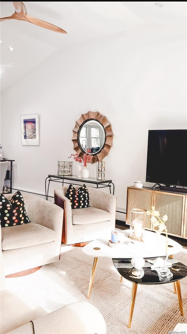 living room featuring baseboard heating and lofted ceiling