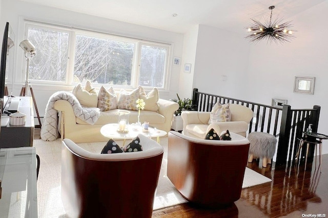 living room with hardwood / wood-style floors and a notable chandelier