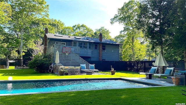 rear view of property featuring a lawn and a patio area