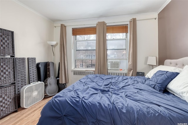 bedroom with hardwood / wood-style flooring, cooling unit, and crown molding