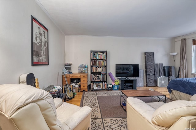 living room with light hardwood / wood-style floors and crown molding