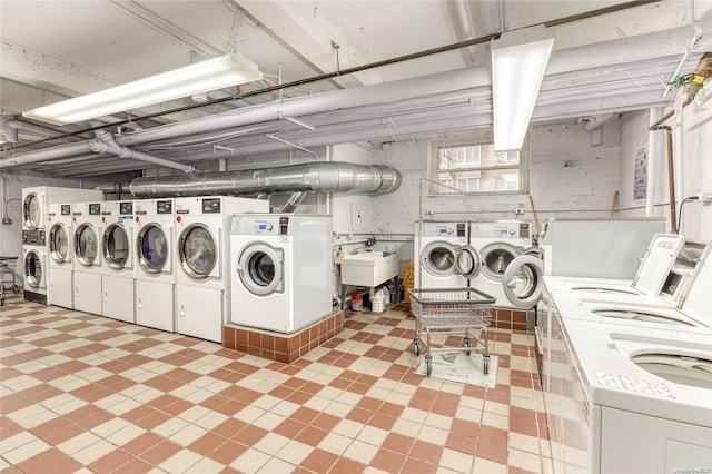 clothes washing area featuring washing machine and clothes dryer and sink