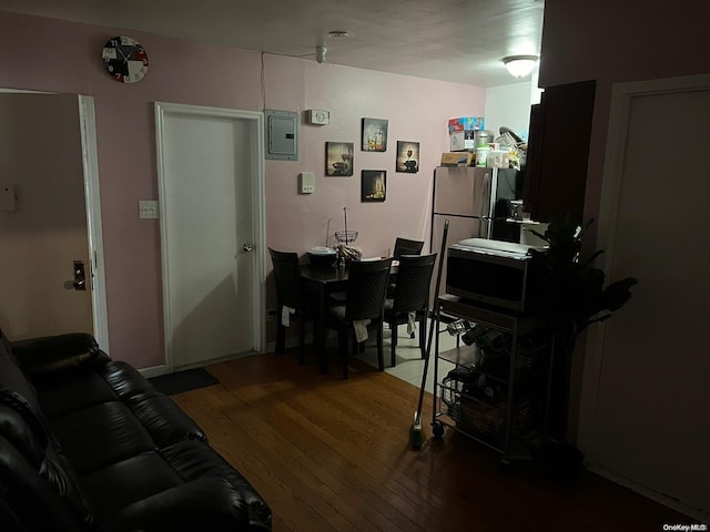 living room with hardwood / wood-style flooring and electric panel