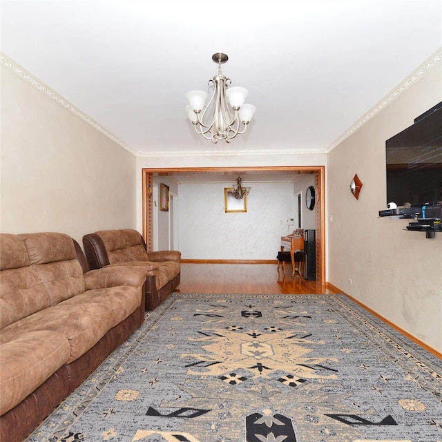 living room featuring wood-type flooring, an inviting chandelier, and ornamental molding