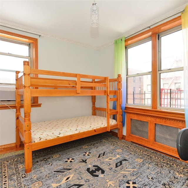 bedroom with multiple windows and crown molding