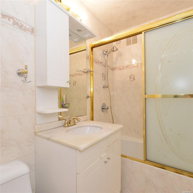 full bathroom with vanity, toilet, and shower / bath combination with glass door