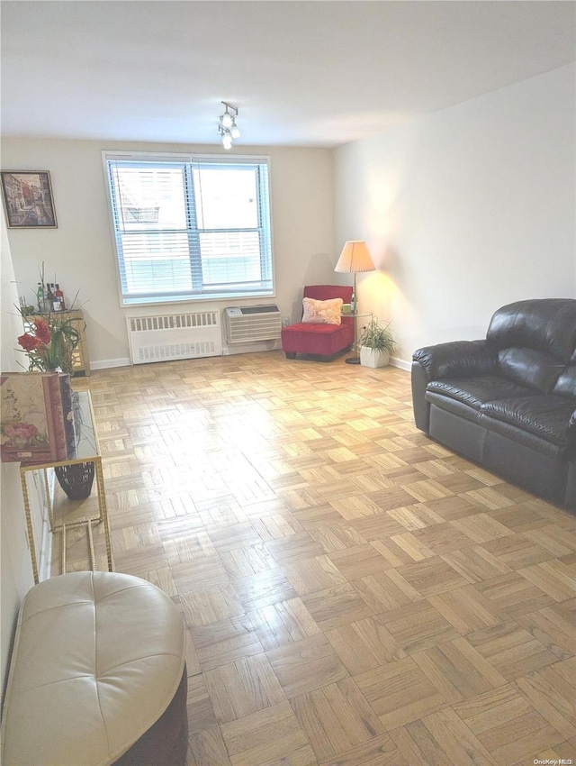 living area with radiator and light parquet flooring