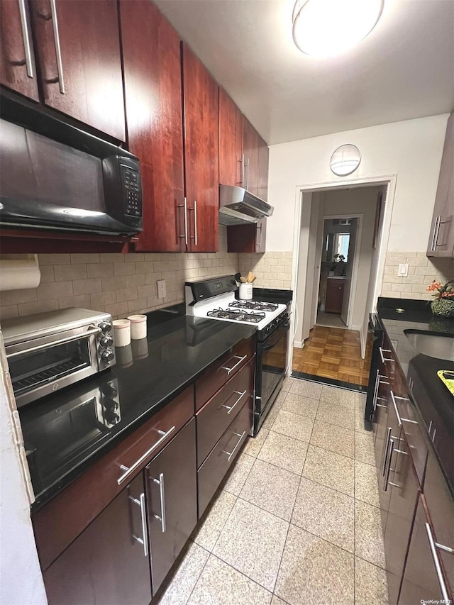 kitchen with backsplash, white gas stove, and sink