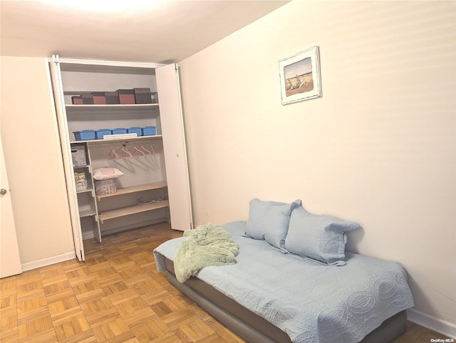 bedroom with light parquet flooring