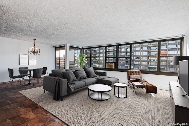 living room with a chandelier, a textured ceiling, and a wall of windows