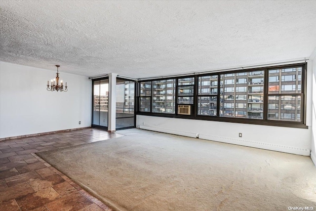 unfurnished room featuring dark colored carpet, a textured ceiling, and an inviting chandelier