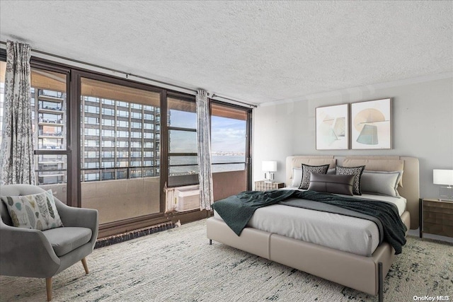 carpeted bedroom with floor to ceiling windows, cooling unit, and a textured ceiling