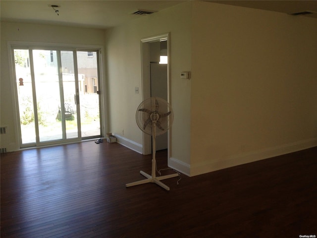 empty room with dark hardwood / wood-style floors