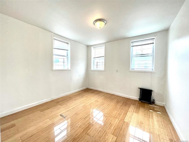 unfurnished room with light wood-type flooring