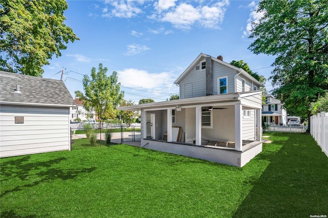 back of house featuring a yard