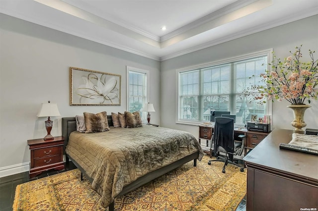 bedroom featuring a tray ceiling, dark hardwood / wood-style flooring, and ornamental molding