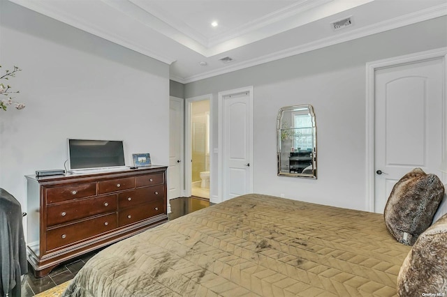 bedroom with ensuite bath, dark hardwood / wood-style floors, and ornamental molding