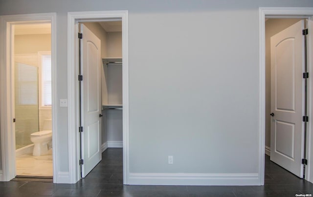 unfurnished bedroom with ensuite bathroom, a closet, and a spacious closet