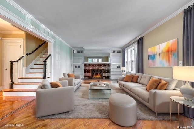 living room featuring a fireplace, wood-type flooring, and ornamental molding