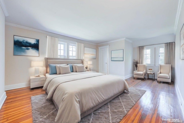 bedroom featuring hardwood / wood-style flooring and crown molding