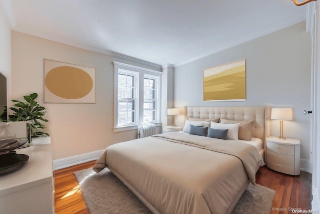 bedroom featuring crown molding and wood-type flooring