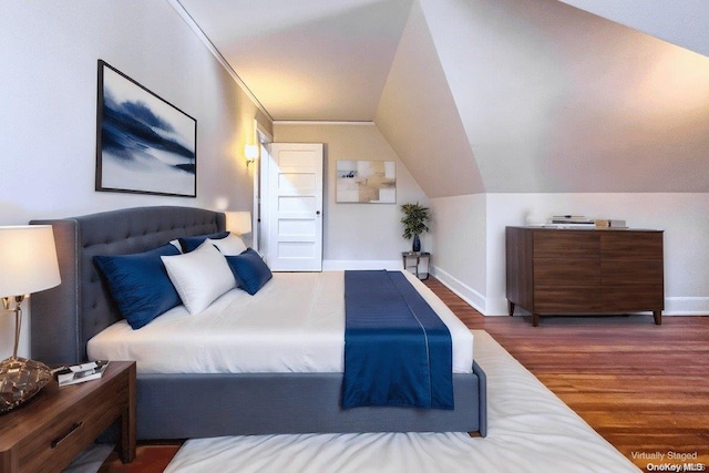 bedroom with dark wood-type flooring and vaulted ceiling