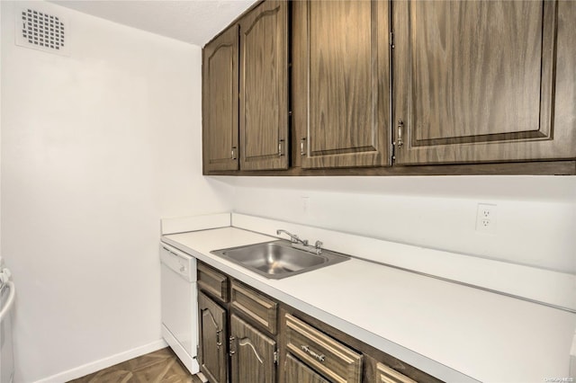 kitchen featuring dishwasher, dark brown cabinetry, and sink