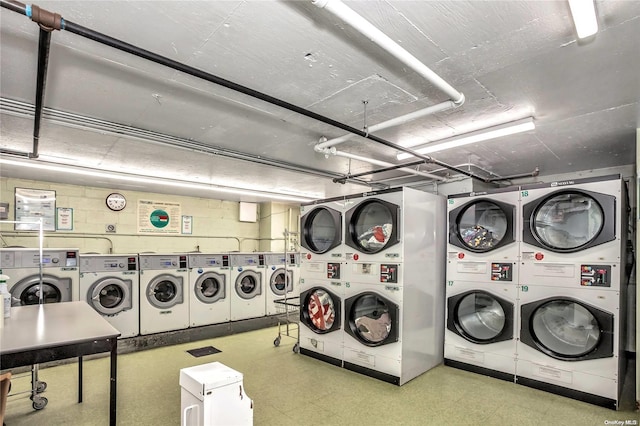 clothes washing area with washing machine and clothes dryer and stacked washer / drying machine